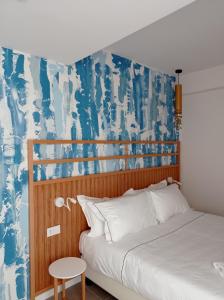 1 dormitorio con 1 cama y una pared azul y blanca en B&B Giro Di Boa, en Lampedusa