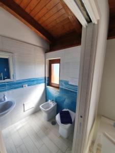 a bathroom with a toilet and a sink at Colle Del Mirto in Castelnuovo Cilento +82 photos
