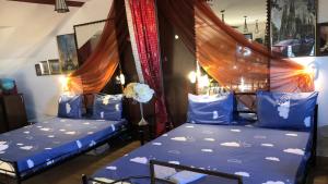 two beds in a room with blue sheets at Gabi Guesthouse in Constanţa