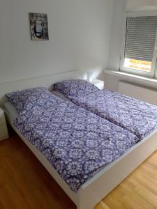 1 cama con edredón morado en un dormitorio en Ruhige zentrale Lage in Bad Honnef, en Bad Honnef am Rhein