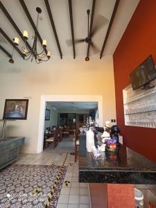 a kitchen and dining room with red and yellow walls at Hotel Las Monjas in Mérida