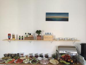 a kitchen counter with plates of food on it at Pod Różą Economy in Łeba
