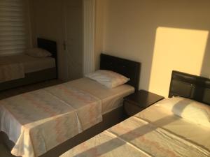 Postel nebo postele na pokoji v ubytování Villa Rüzgargülü wind rose