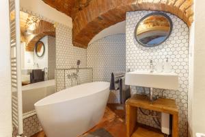 a bathroom with a large white tub and a sink at Apartments No 126 Loket in Loket