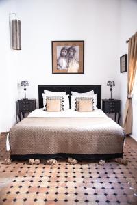 a bedroom with a large bed and two night stands at Riad Lyon-Mogador in Essaouira