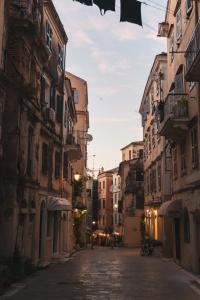 an empty street in an alley with buildings at Roof Garden House in Corfu Town