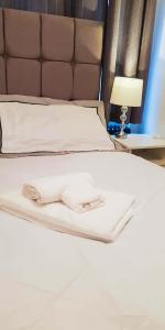 a bed with white sheets and a brown headboard at Room in Guest room - Newly Built Private Ensuite In Dudley Westmidlands in Dudley