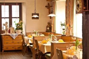 a dining room with tables and chairs with yellow napkins at Hotel Restaurant Lindenhof in Bräunlingen +23 photos