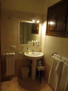 a bathroom with a sink and a mirror and towels at Il Borgo di Tresana in Tresana +37 photos