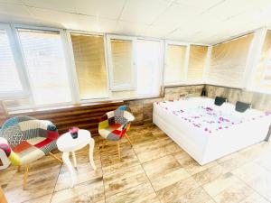 een kamer met een bed, stoelen en ramen bij Ale Park Hotel Apartments in Antalya