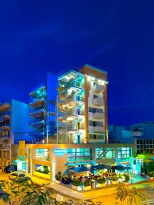 a large building with blue lights at night at Habitat Hotel in Kilkis