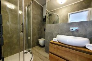 a bathroom with a sink and a shower at Al Mar - Hvar in Hvar