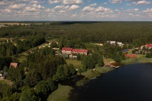 an aerial view of a house next to a lake at Gościniec Kukle in Kukle