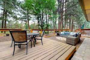 a patio with a table and chairs on a deck at Cozy Mountain Townhome in Flagstaff