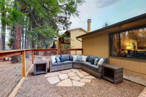 - un canapé installé sur une terrasse à côté d'une maison dans l'établissement Cozy Mountain Townhome, à Flagstaff