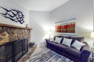 a living room with a couch and a fireplace at Cozy Mountain Townhome in Flagstaff