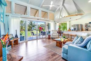 a living room with a blue couch and a table at Pali Ke Kua #3 in Princeville