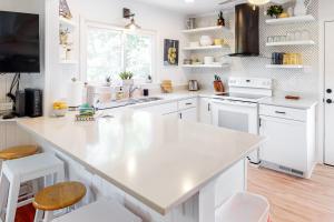 a white kitchen with a large white counter top at All Decked Out in Edisto Beach
