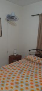 a bedroom with a bed with an orange and yellow blanket at cambulos 2 in Cali