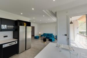 a kitchen with a refrigerator and a living room at Swan Lake - Design apartment facing Lake Annecy in Annecy