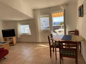a living room with a table and a television at Apartments Papic in Trogir