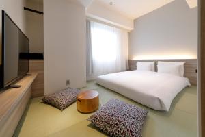 เตียงในห้องที่ Glocal Hotel Itoshima