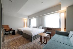 Postel nebo postele na pokoji v ubytování Glocal Hotel Itoshima