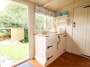 a kitchen with a sink and a window at Orchard in Wadebridge