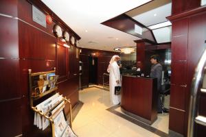 a bride standing at a counter in a restaurant at Al Jazeera Royal Hotel in Abu Dhabi