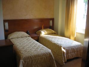 A bed or beds in a room at Albergo Ristorante Montebaldo