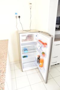 a refrigerator with its door open in a kitchen at Karen View Palace Apartments in Nairobi