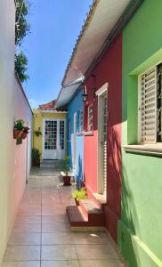 a row of colorful houses with a pathway at Casa com ótima localização in Piracicaba