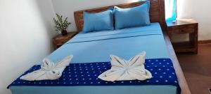 Postel nebo postele na pokoji v ubytování Turtle Island Homestay
