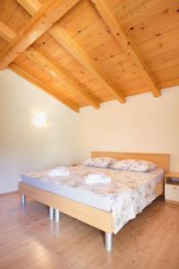 ein großes Bett in einem Zimmer mit Holzdecken in der Unterkunft Apartment Josipa in Vis