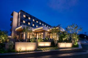 a building at night with its lights on at Glocal Hotel Itoshima in Itoshima