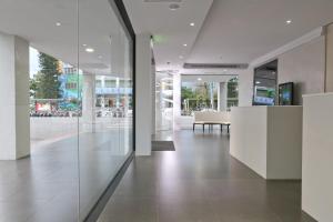 a hallway of a building with white walls and glass at The Fantasy Apartment in Hualien City