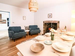 a dining room with a table and a fireplace at Water Street in Aberaeron