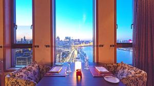 a dining room table with a view of the ocean at Hotel Indigo Shanghai On The Bund, an IHG Hotel in Shanghai