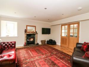 a living room with a couch and a fireplace at Tigh Na Drochit in Garve