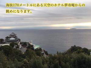 um castelo no topo de uma colina na água em Mujuan em Atami