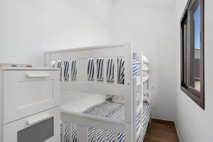 a white closet with white shelves and a window at Casa Jaime in Conil de la Frontera +13 photos