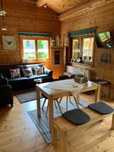 a living room with a table and a couch at Ferienhaus Vulkaneifel Bei Hepp in Schönbach