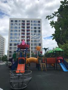 a playground in front of a tall building at 21 Residence Apartments in Bucharest