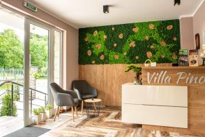 a lobby with two chairs and a wall with a ivy at Villa Pino in Velingrad