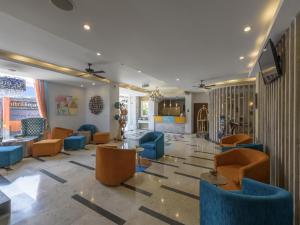 a lobby with blue chairs and a waiting room at Destiny Boutique Hotel in Seminyak