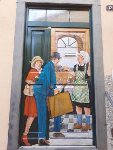 a painting of three people standing in a kitchen at Ca' Du Batan in Spotorno