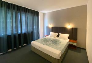 Postel nebo postele na pokoji v ubytování Hotel Opal