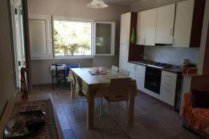 a kitchen with a table and a table and chairs at Otranto selva del turchese in Otranto