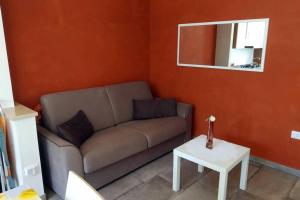 a living room with a couch and a mirror at Otranto selva del turchese in Otranto