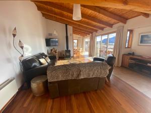 a living room with a couch and a table at Glacier Rock Lakeview House in Lake Tekapo